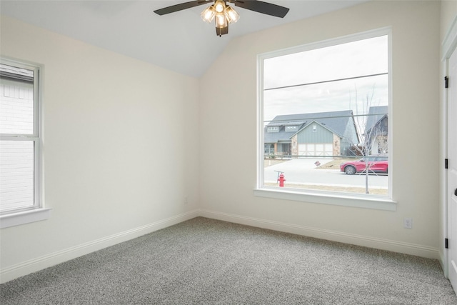 carpeted empty room with ceiling fan and vaulted ceiling