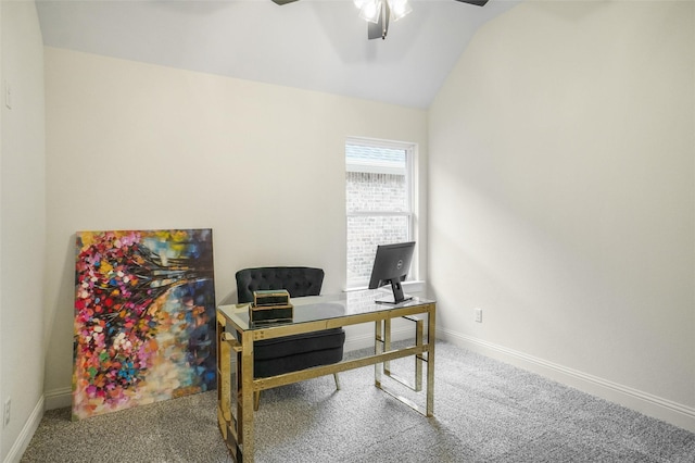 carpeted home office featuring lofted ceiling and ceiling fan