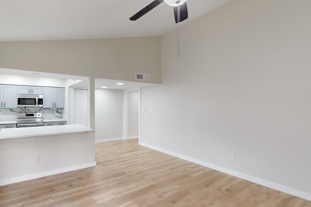 unfurnished living room featuring light hardwood / wood-style flooring, high vaulted ceiling, and ceiling fan