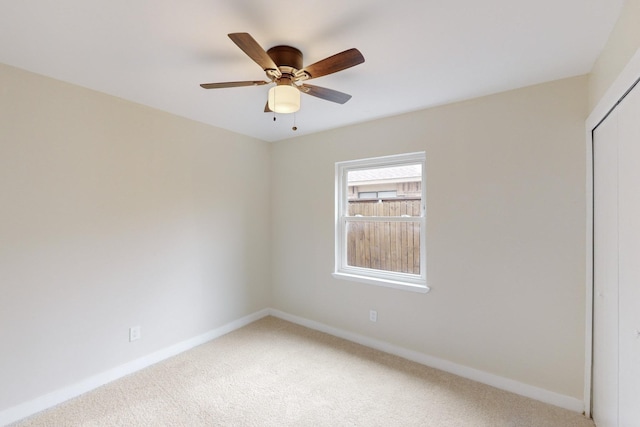 empty room featuring ceiling fan and carpet flooring