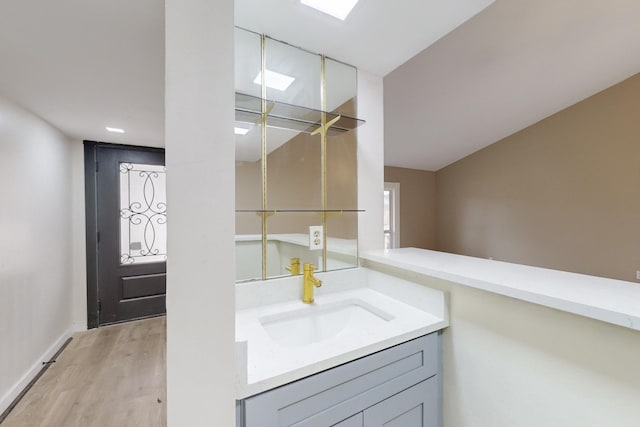 bathroom with vanity and hardwood / wood-style floors