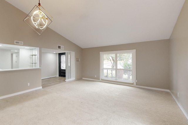 unfurnished living room featuring high vaulted ceiling and light colored carpet