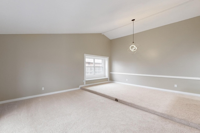 unfurnished room featuring vaulted ceiling and carpet floors