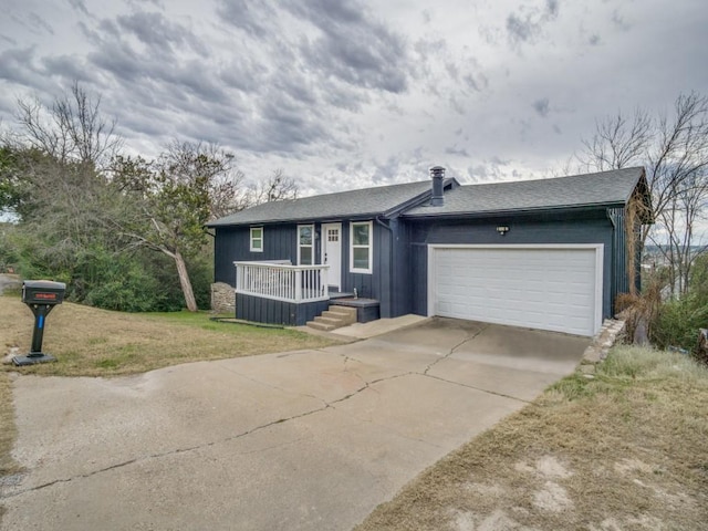 single story home with a front yard and a garage