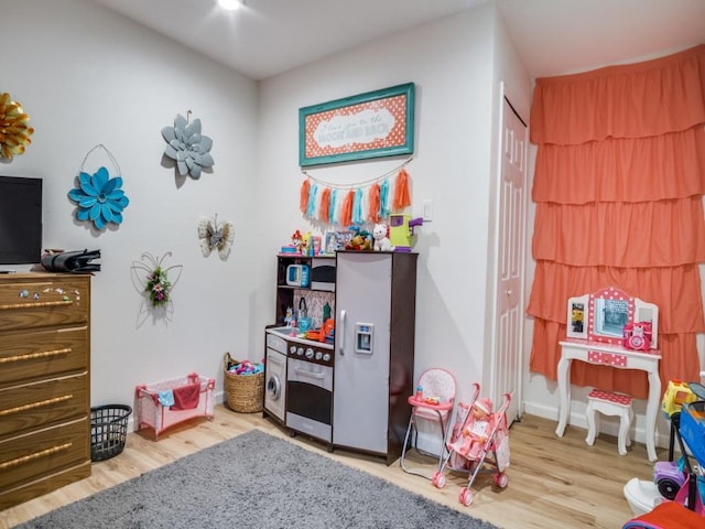 game room with light hardwood / wood-style floors