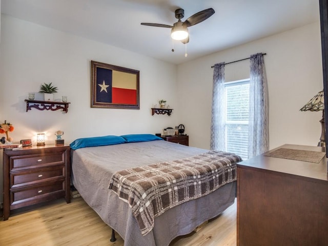 bedroom with ceiling fan and light hardwood / wood-style flooring