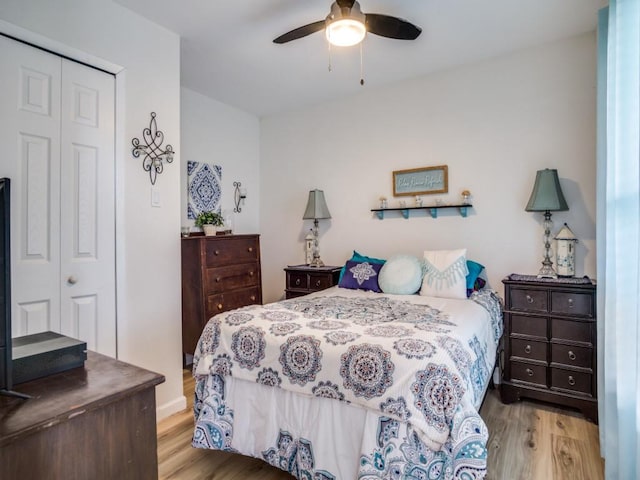 bedroom featuring ceiling fan, a closet, and light wood-type flooring