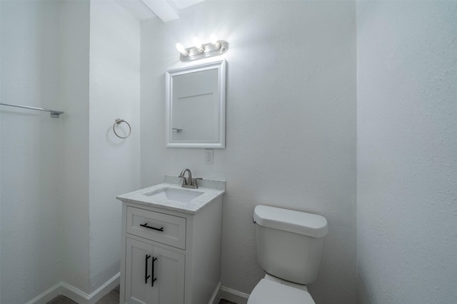 bathroom with toilet and vanity