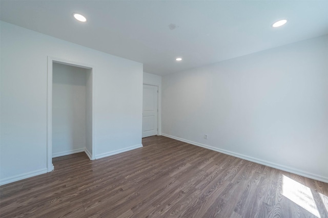 unfurnished bedroom with a closet and dark hardwood / wood-style flooring