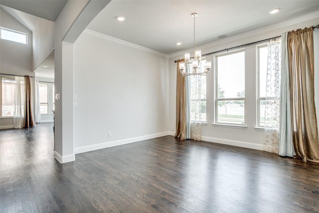 spare room with dark hardwood / wood-style flooring, ornamental molding, and a notable chandelier