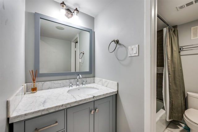 full bathroom featuring toilet, vanity, and shower / tub combo