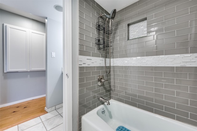 bathroom featuring tiled shower / bath and tile patterned flooring