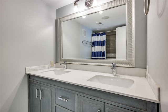 bathroom with walk in shower and vanity