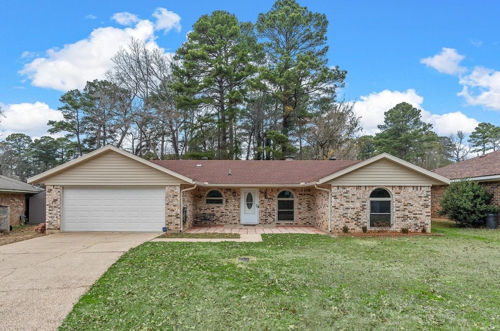 ranch-style home with a front yard and a garage