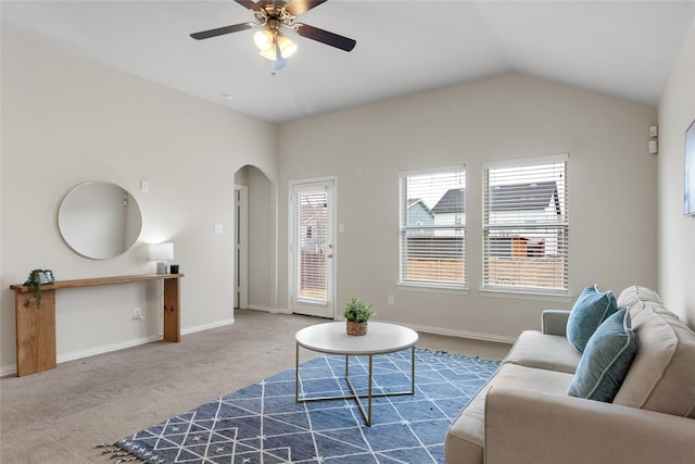 carpeted living room featuring ceiling fan and vaulted ceiling