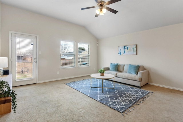 living room featuring ceiling fan, vaulted ceiling, and carpet flooring