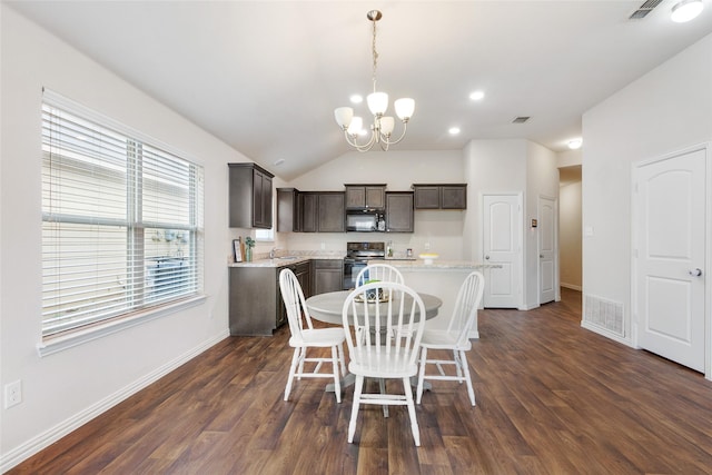 dining area with vaulted ceiling, an inviting chandelier, dark hardwood / wood-style floors, and sink