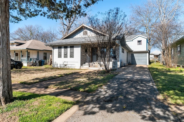 view of front facade featuring a front lawn, a porch, and a garage