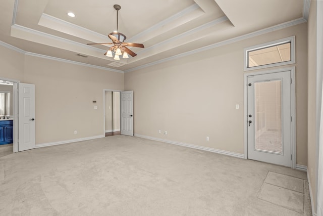 unfurnished room with ceiling fan, a tray ceiling, and crown molding