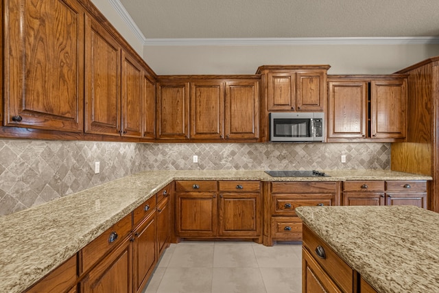 kitchen featuring light tile patterned floors, backsplash, black electric cooktop, light stone countertops, and ornamental molding