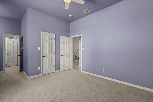 unfurnished bedroom with ceiling fan and light carpet