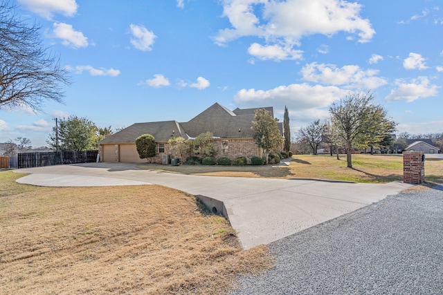 view of front of home with a front lawn and a garage