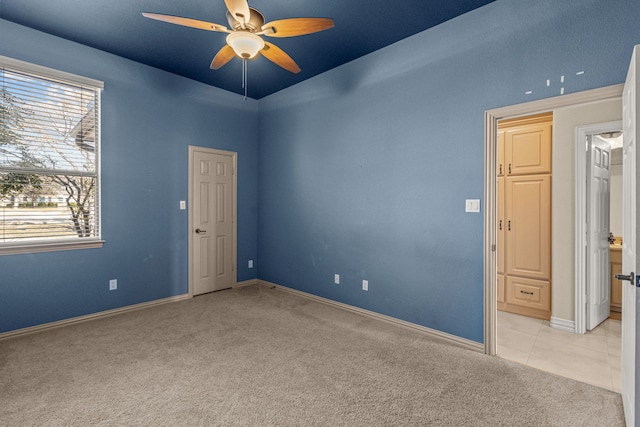 carpeted spare room featuring ceiling fan