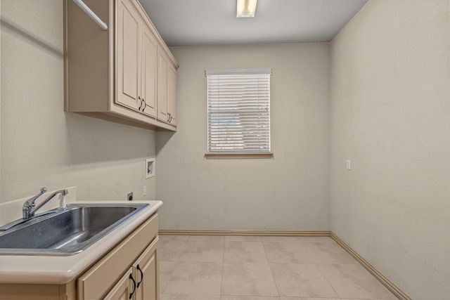 washroom featuring light tile patterned floors, electric dryer hookup, washer hookup, cabinets, and sink