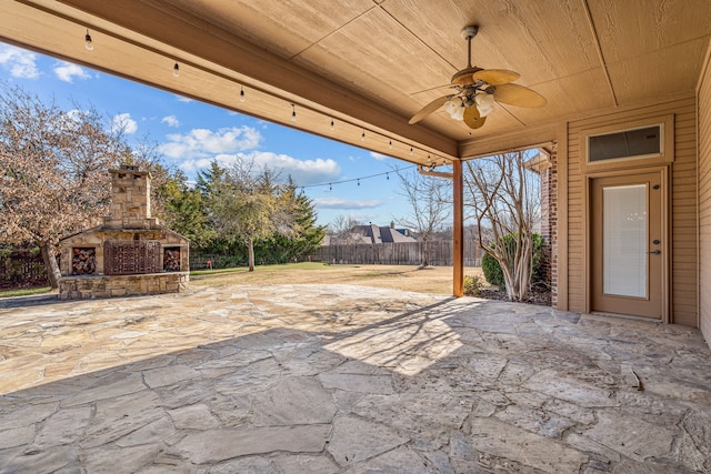 view of patio featuring ceiling fan and an outdoor stone fireplace