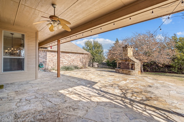 view of patio / terrace featuring ceiling fan and an outdoor stone fireplace