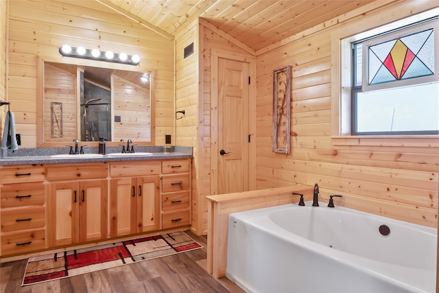 bathroom featuring hardwood / wood-style flooring, wooden walls, wooden ceiling, lofted ceiling, and vanity