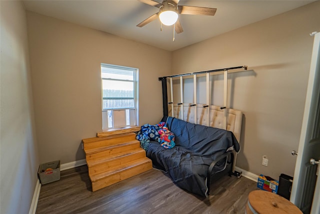 living area with ceiling fan and dark wood-type flooring