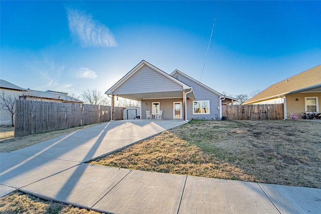 view of front of property with a front yard and a storage unit