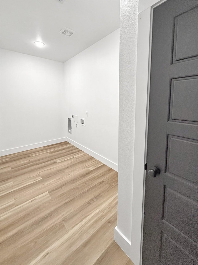 laundry room with washer hookup, light hardwood / wood-style floors, and hookup for an electric dryer