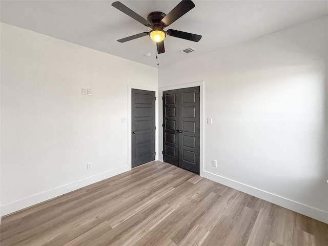 unfurnished bedroom with ceiling fan and light hardwood / wood-style flooring