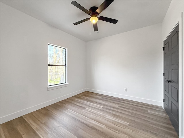 unfurnished room with ceiling fan and light wood-type flooring