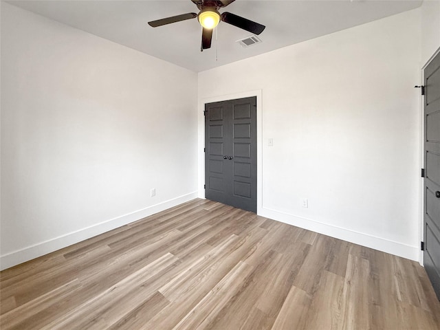 unfurnished bedroom featuring ceiling fan, a closet, and light hardwood / wood-style floors