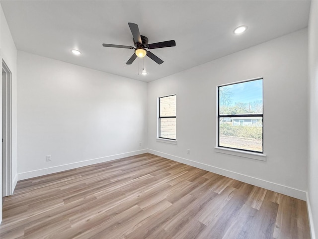 spare room with ceiling fan and light hardwood / wood-style floors