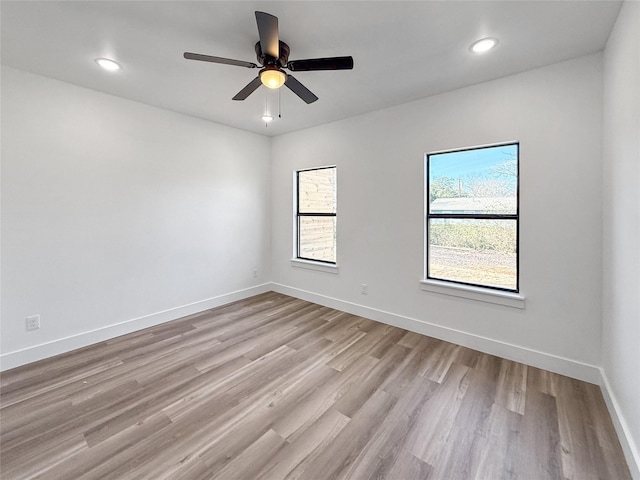 unfurnished room featuring light hardwood / wood-style floors and ceiling fan