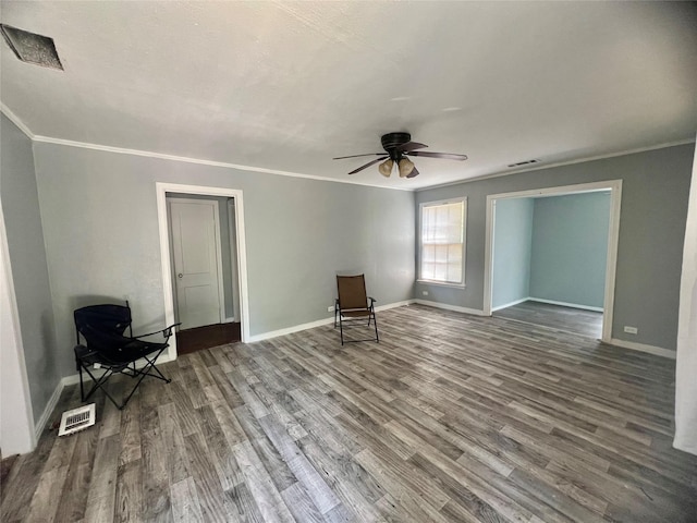 unfurnished room featuring ceiling fan, wood-type flooring, and ornamental molding