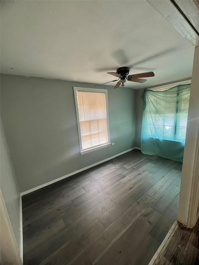 empty room featuring ceiling fan and dark hardwood / wood-style floors