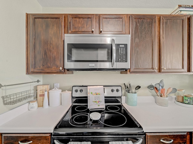 kitchen with stainless steel appliances and a textured ceiling