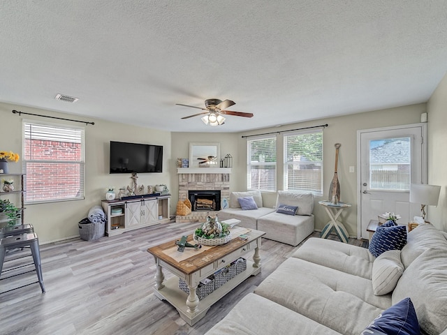 living room with a textured ceiling and a healthy amount of sunlight