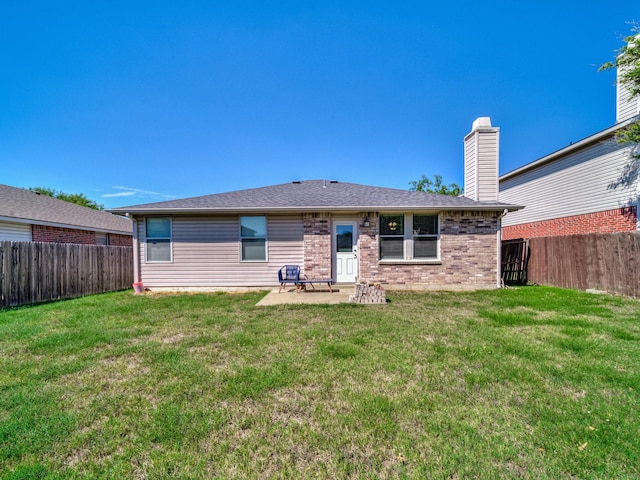 back of property featuring a patio and a lawn