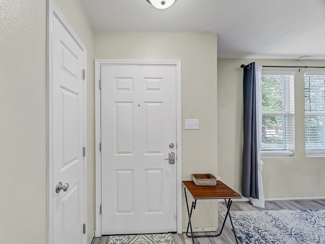 entryway featuring a textured ceiling and light wood-type flooring