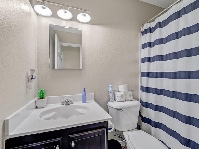 bathroom featuring vanity, toilet, and a shower with shower curtain