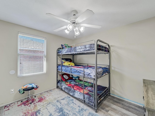 bedroom with ceiling fan and hardwood / wood-style floors