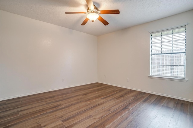 unfurnished room featuring ceiling fan, dark hardwood / wood-style floors, and a textured ceiling