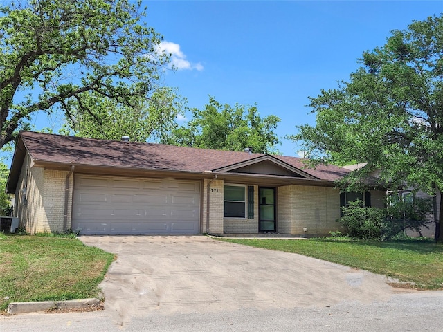 ranch-style home featuring brick siding, an attached garage, driveway, and a front lawn