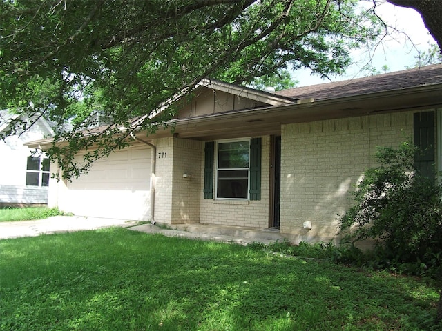single story home featuring a garage, a front yard, roof with shingles, brick siding, and board and batten siding